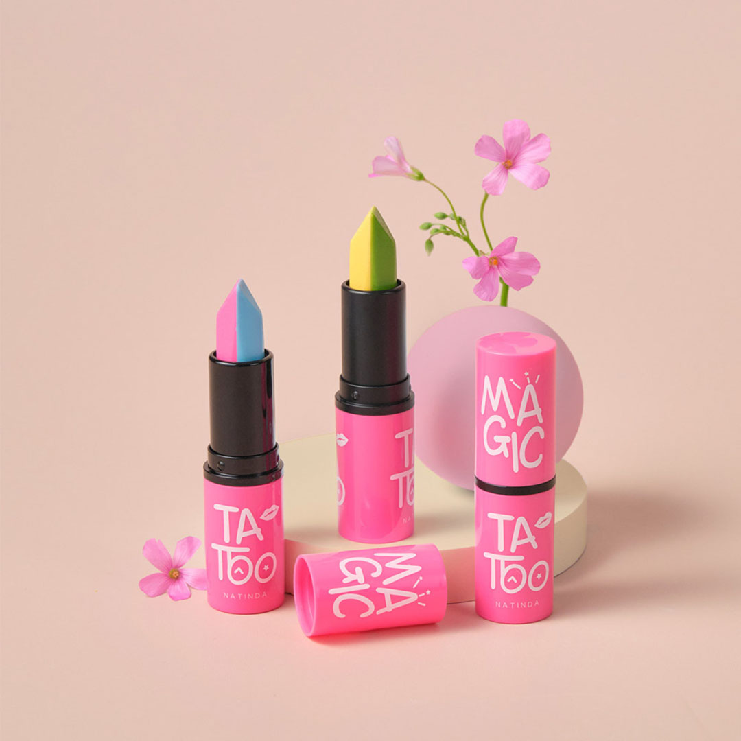 Colorful lipsticks with 'Tattoo' and 'Magic' text on a pink background