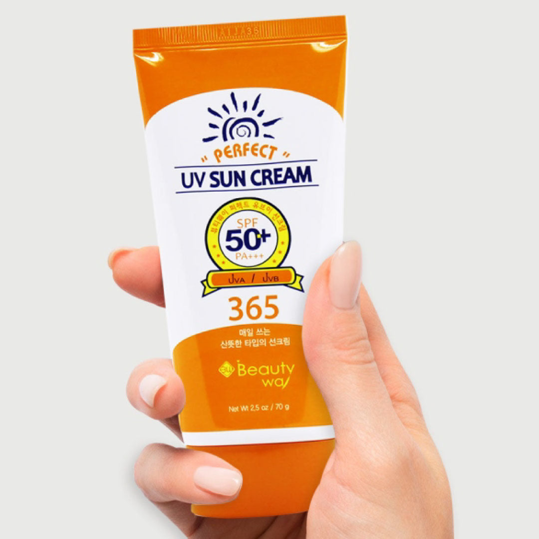 Hand holding a tube of BeautyWay Perfect UV Sun Cream SPF50+ PA+++ 70g, Korean sunscreen, on a white background