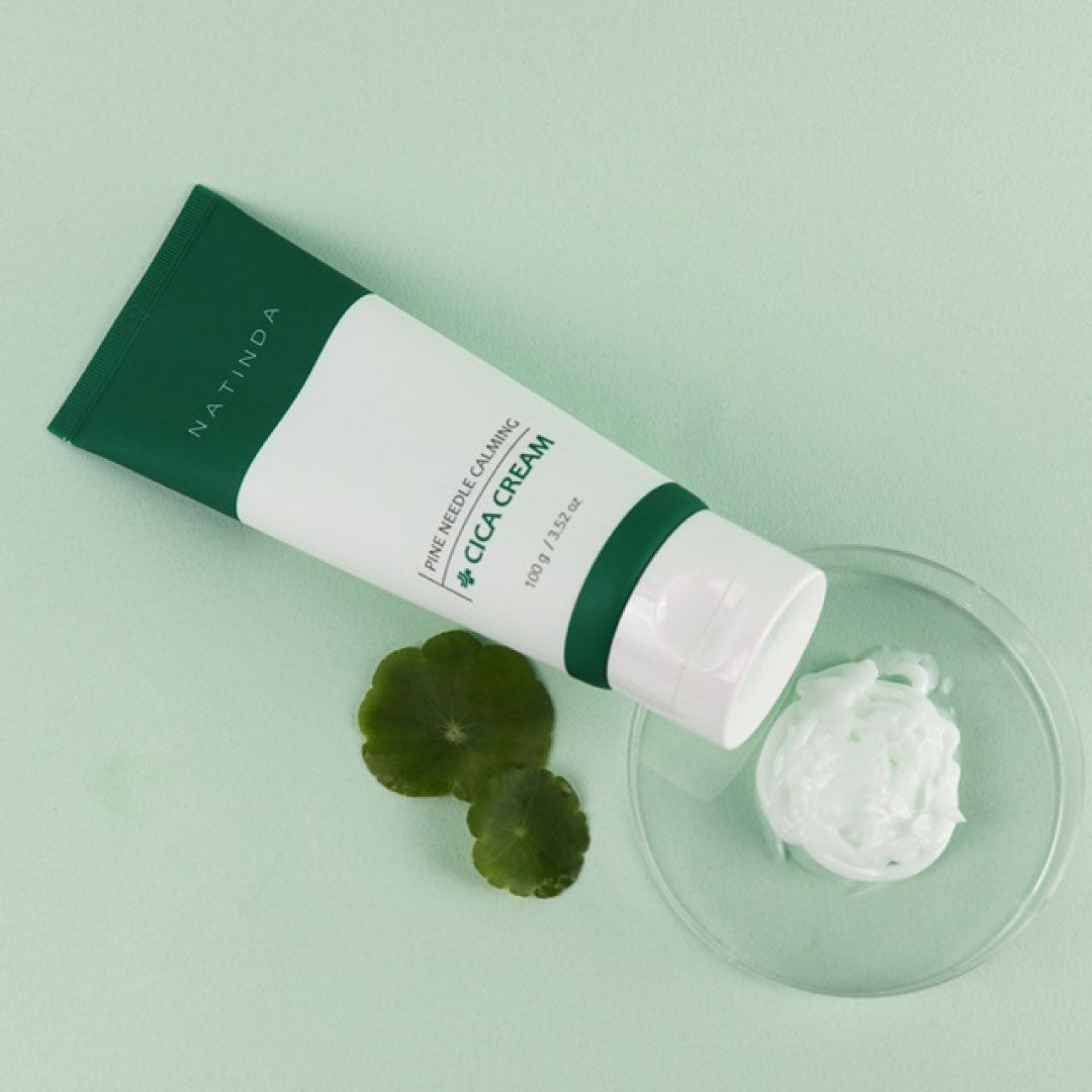 Cica cream tube with green leaves on a light green background